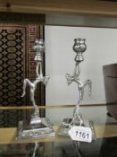 A pair of chrome art deco figural candlesticks.