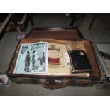 A suitcase full of miscellaneous ephemera including cigarette cards, county maps, Harmsworth prints,