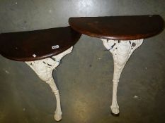 A pair of cast iron hall tables.