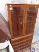 A mahogany effect music cabinet with drawers.