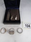 A silver ingot, a pair of silver ingot earrings, a silver coin ring and 2 other silver rings.