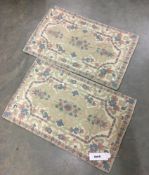 A pair of silk embroidered rugs (36 in x 24 in)