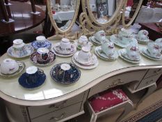 A 21 piece tea set and various cups and saucers.