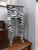 A single drawer zebra patterned side table.