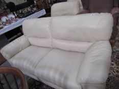 A cream leather 3 seat sofa.