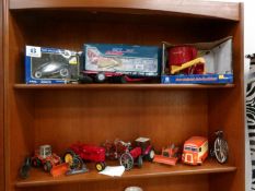 A quantity of boxed and unboxed farm tractors, bicycles etc.