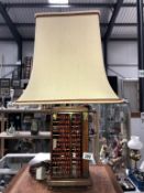 An unusual table lamp with sides in the form of abacus's and complete with shade.