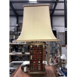 An unusual table lamp with sides in the form of abacus's and complete with shade.