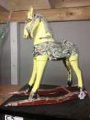 An unusual small 18" high early rocking horse, distressed.