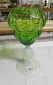 A green and vaseline art glass vase.