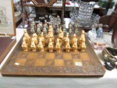A chess set with board with heraldic birds and beasts pieces.