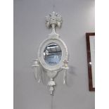 A shabby chic wall mirror with candle sconces.