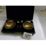 A cased pair of silver salts with spoons.