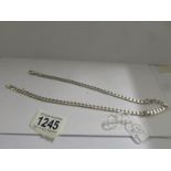 A silver kerb link chain (20"), 30.8 grams.