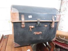 An old dome top travelling trunk.