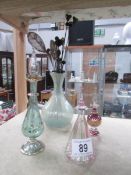 3 glass perfume bottles, a glass vase and a quantity of hat pins.