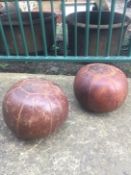 A Pair of early 20th Century leather vintage medicine balls - ideal children's footstools.