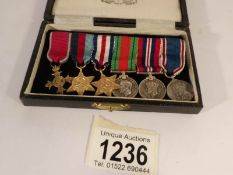 A cased set of 6 miniature medals including O.B.E.