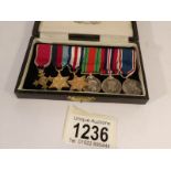 A cased set of 6 miniature medals including O.B.E.