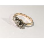 An 18ct gold and platinum ring set 3 diamonds.