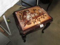 A small coffee table with picture of owls in top signed G Cundill.