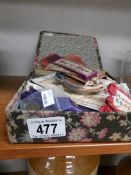 A box of assorted silks and needlework.