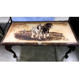 A coffee table with picture of shire horses in top signed G Cunhill.