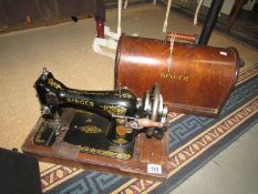 A cased Singer sewing machine.