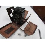 A Rolleicord Compur camera with case.