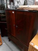 A mahogany effect TV cabinet.