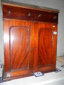 A mahogany 2 drawer, 2 door cupboard, a/f.