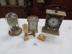 A brass carriage clock and 4 other clocks.