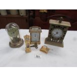 A brass carriage clock and 4 other clocks.