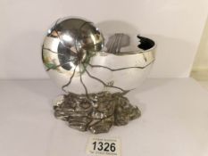 A silver plated nautilus shell spoon warmer by Atkin Brothers and designed by Christopher Dresser.