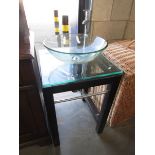 A modern glass wash basin on stand.