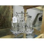 A 6 bottle Victorian cruet on silver plated stand, missing one stopper.