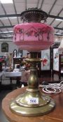 A Victorian oil lamp base with hand painted glass font.