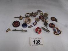 A mixed lot of badges including enamel, military etc.