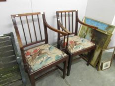 A pair of mahogany elbow chairs,.