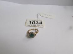A 9ct gold ring set green and white stones, size I.