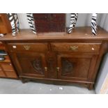 An oak arts and crafts sideboard.