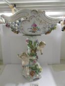 A Miessen porcelain centre piece supported by cherubs.