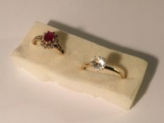 A diamond/ruby cluster ring and a white stone ring both in 9ct gold.