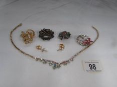 A necklace, 4 brooches and a pair of cross earrings.