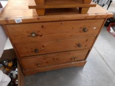 A 3 drawer pine chest.