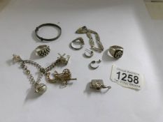 A mixed lot of silver including charm bracelet.