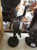 A bronze winged cherub figure, 33cm/13" tall.