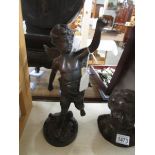 A bronze winged cherub figure, 33cm/13" tall.