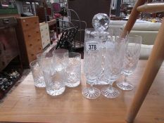 A crystal decanter with silver gin label, 6 whisky glasses and 6 champagne flutes.