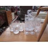 A crystal decanter with silver gin label, 6 whisky glasses and 6 champagne flutes.